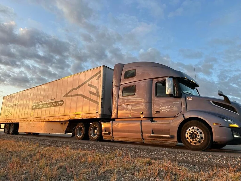 Blackbird tractor-trailer, unit 759, on the highway in warm golden-hour light