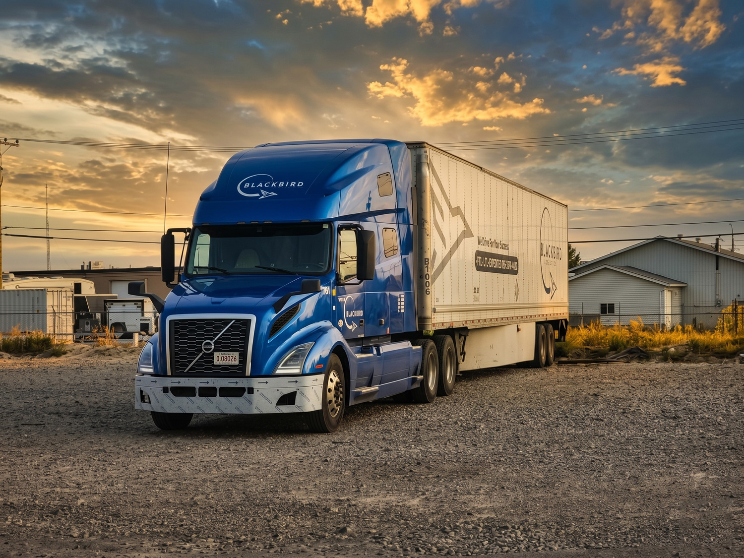 Blue Blackbird sleeper tractor, unit 761, pulling a white dry van trailer